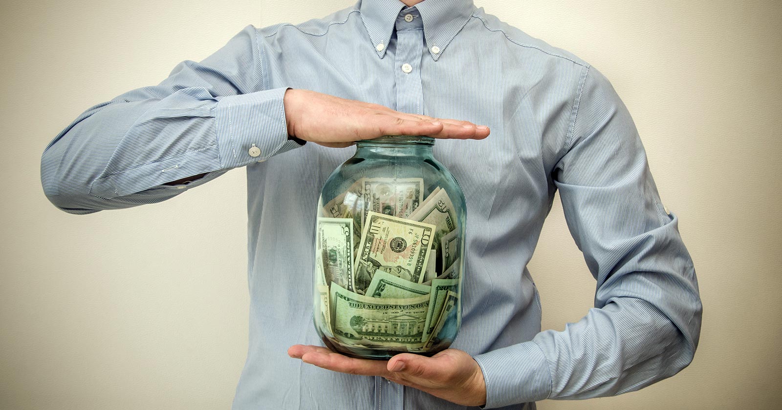 cash basis in accounting, guy holding jar of money